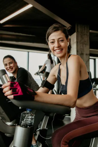 Indoor Cycling Instructor smiling on a stationary bike